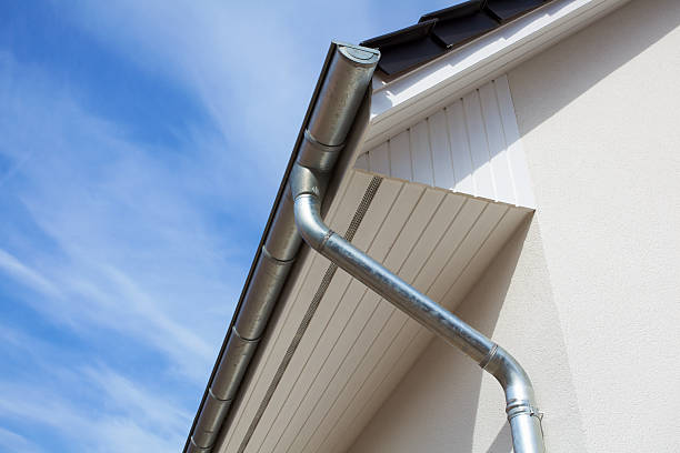 Architectural close-up of a metal rain gutter with downspout Rain gutter or Eavestrough with downspout maked of steel galvanized. eaves stock pictures, royalty-free photos & images