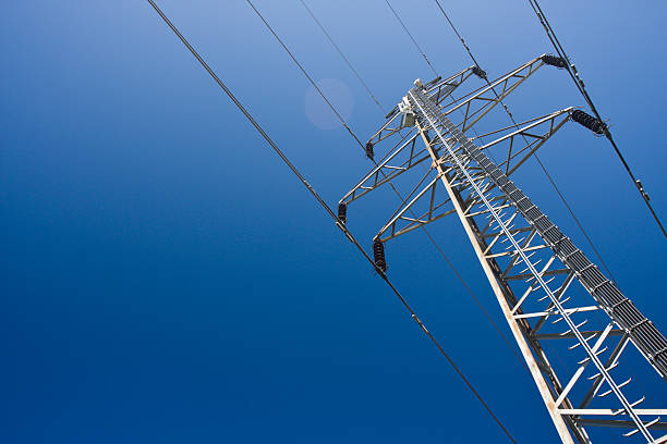 A group view of an electric tower Electricity pylon on a clear blue sky. power cable photos stock pictures, royalty-free photos & images
