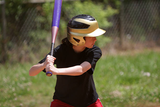 istock Girl batting in softball 471188653