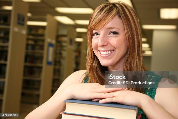Giovane Studente Di College Con I Libri Nella Libreria - Fotografie stock e altre immagini di Adulto