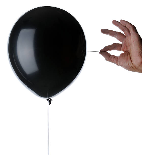 Balloon About to Be Popped with A Needle stock photo