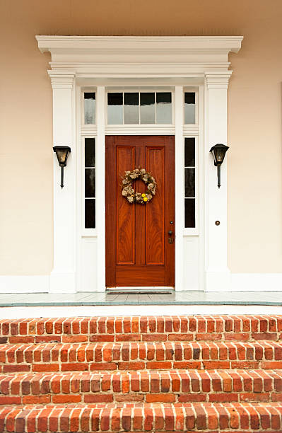 Doorway A beautiful front door on a wooden front porch. front porch stock pictures, royalty-free photos & images