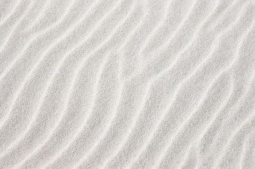 White beach sand formed by wind in waves. Also available in vertical crop: