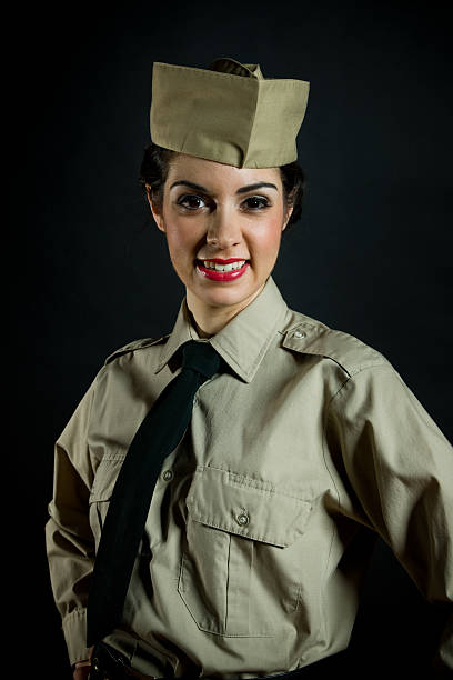 Woman whom is in her United Air Force flight uniform poses in a rustic background.