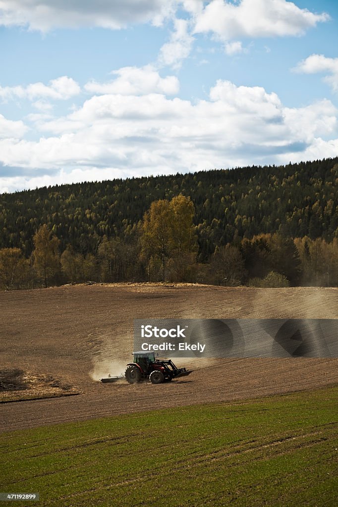 Farmer on his tractor plowing the field. Farmer on his tractor plowing the field. Norway. Farm Stock Photo