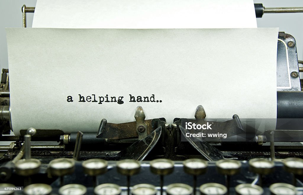 Helping hand The saying "a helping hand" as shown to have bben typed on a vintage typewriter... copy space. Typewriter Stock Photo
