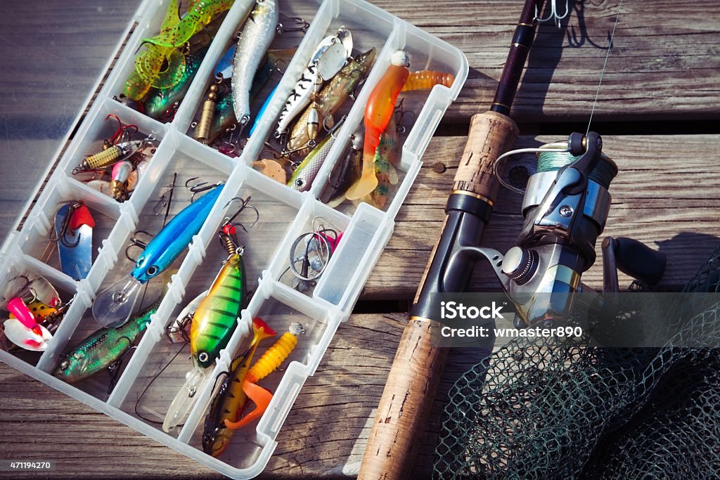 Fishing Lures In Tackle Boxes With Spinning Rod And Net Stock
