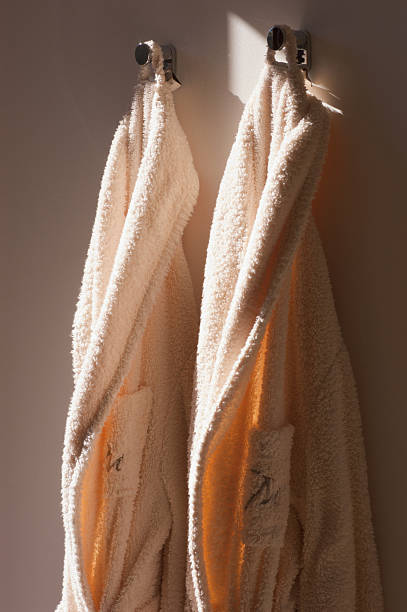istock Two bathrobe hanging at wall. Hotel concept 471194295