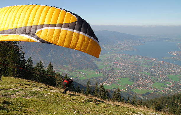 fly away paraglider on top of mountain