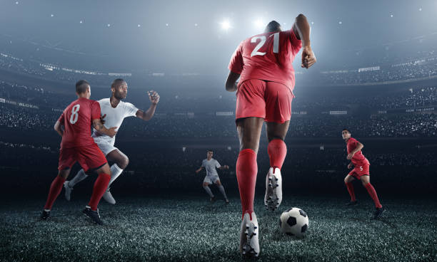 istock Soccer player kicking ball in stadium 471195040