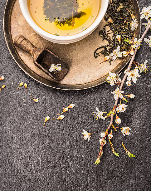 istock Cup of green cherry tea on dark stone background 471195758
