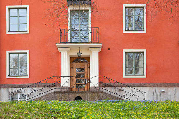 istock Old red house and spring flowers. 471197145
