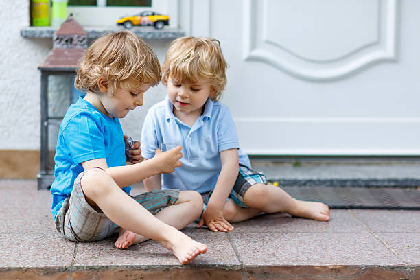 istock Two happy kid boys having fun together outdoors 471197910