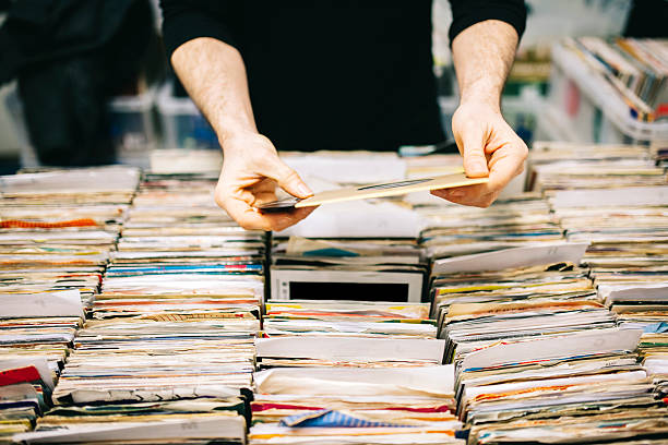 istock Choosing a second hand vinyl record in a record store 471198666
