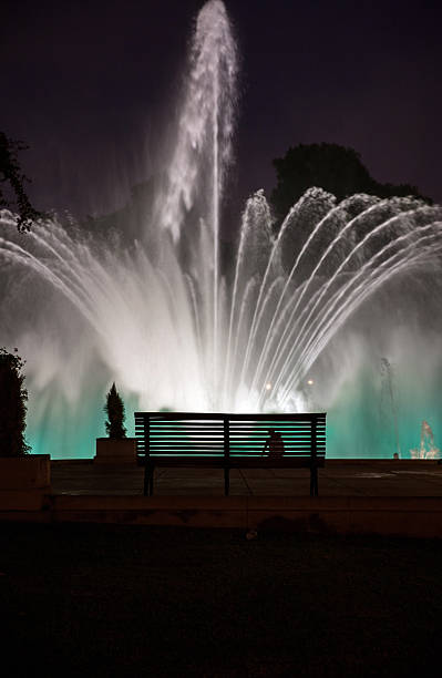istock Empty bench in front of fountain after dark 471199006
