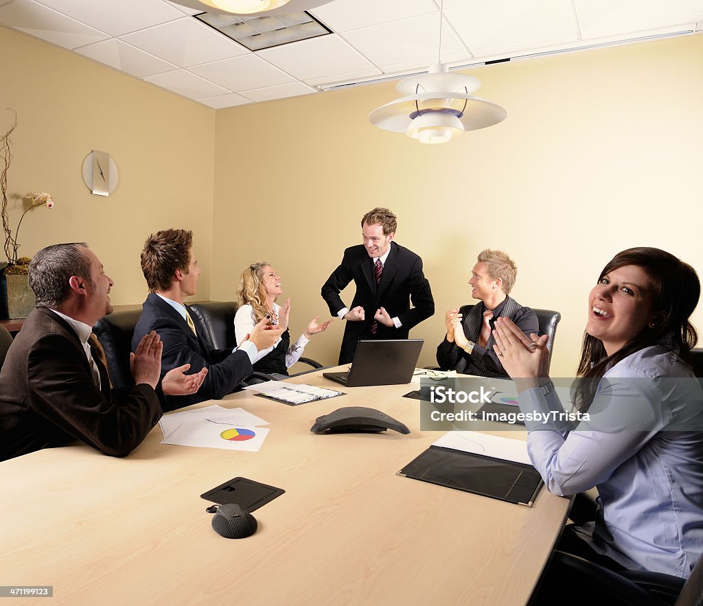 Business Strength Businessman flexes his muscles while his co-workers look on.  All grahs and charts are my own design. 20-29 Years Stock Photo