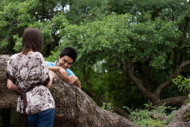 Young couple hanging out at the park. stock photo