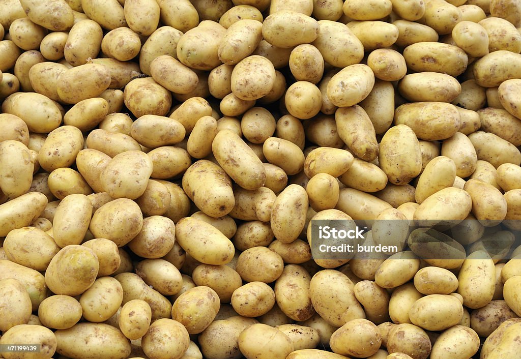 Potatoes Heap of potatoes in the farmer's market, food backgrounds. Vertical shot: Raw Potato Stock Photo
