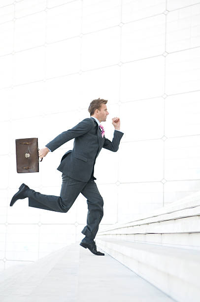 istock Businessman Leaps Upstairs w Briefcase 471199975