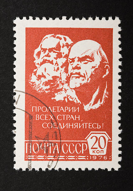 Marx and Lenin on a soviet stamp 1976 Marx and Lenin printed on a stamp with the comunist quote (Пролетарии всех стран, соединяйтесь!)"Workers of the world, unite!" written in Russian. Clipping path is included, you can clip it and paste it in your own revolutionary postal compositions! two heads are better than one stock pictures, royalty-free photos & images