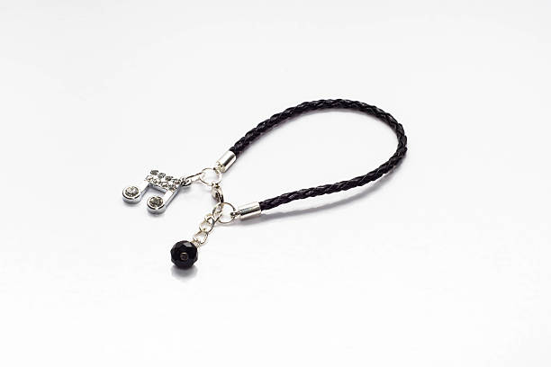 istock Handmade black bracelet with note and crystal on white background 471200654