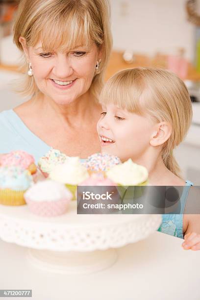 Bambino E Donna Matura Mangiare Cupcake - Fotografie stock e altre immagini di Adulto - Adulto, Adulto in età matura, Anziani attivi