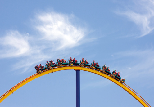 Huge Yellow Rollercoaster on Brilliant Blue sky with \