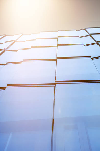 istock bright sunshine over skyscraper with modern glass facade 471204468
