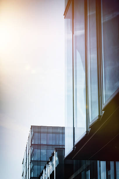 istock bright sunshine over skyscraper with modern glass facade 471204470