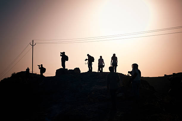 Silhouettes of photographers at sunset.