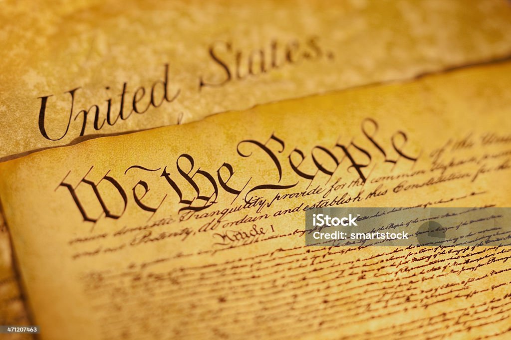 Preamble to Constitution the United States of America We the People are the opening words of the preamble to the Constitution of the USA. This image has a shallow depth of field to emphasize the opening phrase. The document underneath is a copy of the Bill of Rights. American Revolution Stock Photo