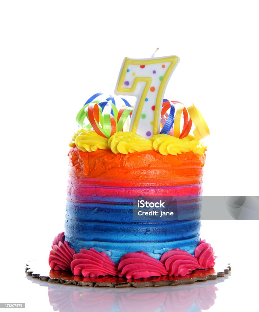 7th Birthday Cake A colorful birthday cake on a white background with a "7" candle Aging Process Stock Photo