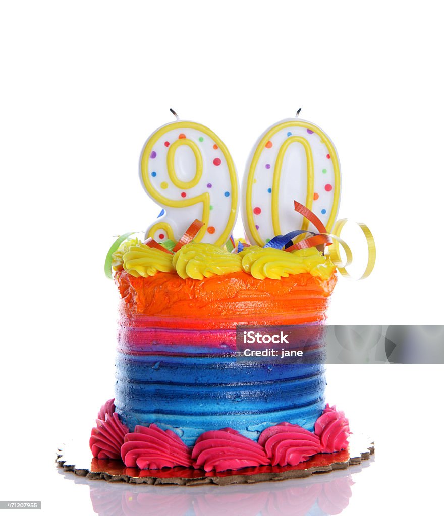 90th Birthday Cake A colorful birthday cake on a white background with a "90" candle Aging Process Stock Photo