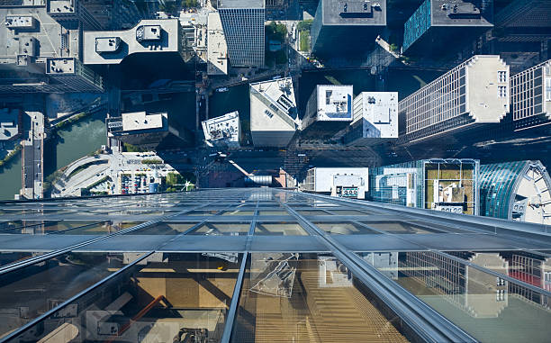 Chicago Rooftops Aerial View of Chicago Rooftops and Chicago River- looking directly down from a new tourist attraction of Sears Tower- "see-through" glass ledges willis tower stock pictures, royalty-free photos & images