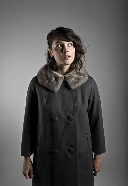 Portrait of a beautiful young woman wrapped up warm in furry winter jacket.