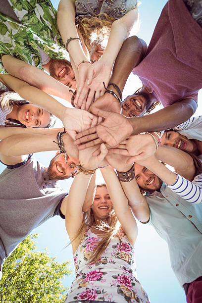 istock Happy young friends putting hands together 471209652