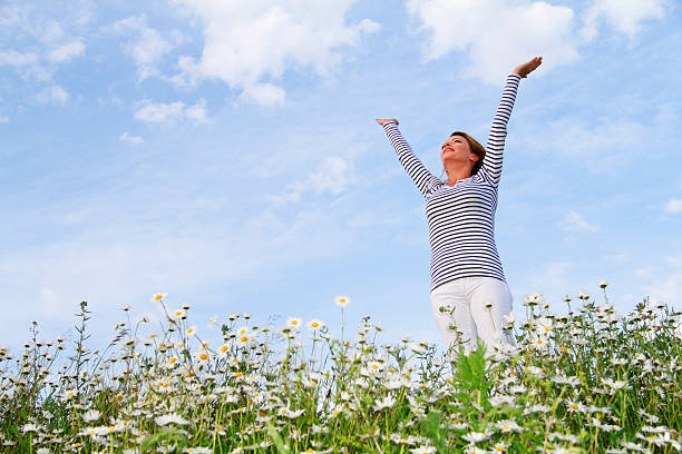 istock Happy woman in flower field 471209752
