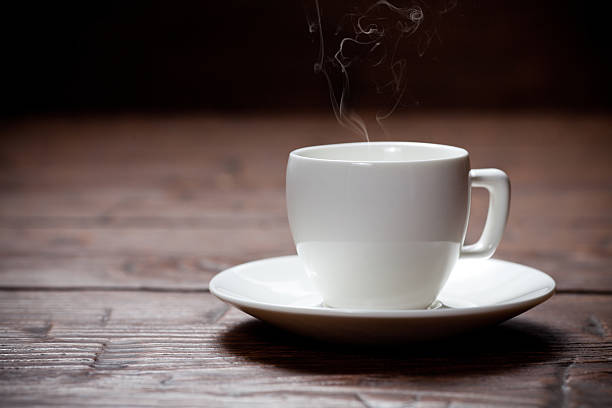 istock Coffee cup and saucer on old wooden table. 471210244