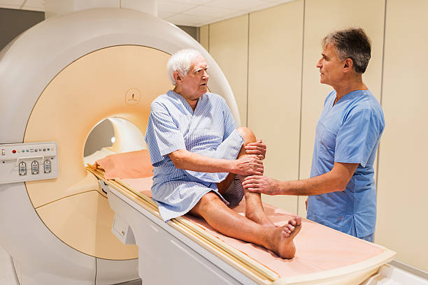istock Mature radiologist discussing with senior patient. 471210628
