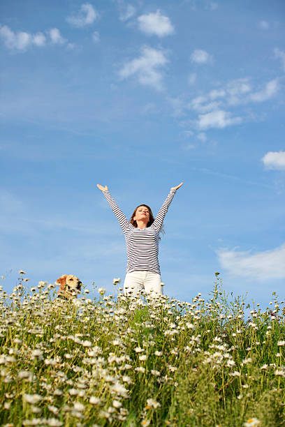istock Happy woman in flower field 471210668