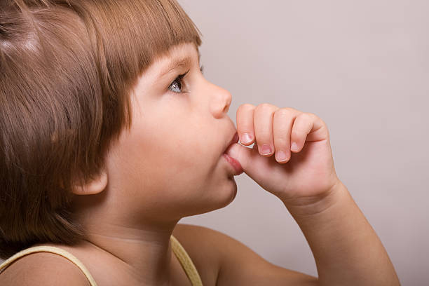 Two years old little ittle girl sucking her thumb