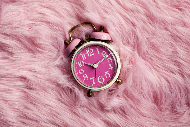 Pink retro alarm clock on fur