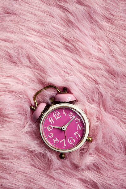 istock Pink retro alarm clock on fur 471211796
