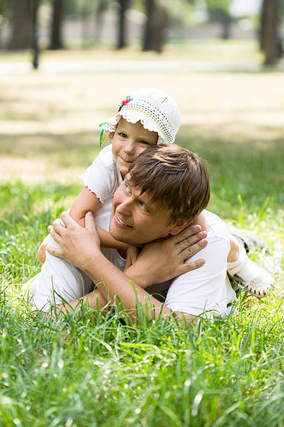 istock Cute little girl lying on grass 471211800