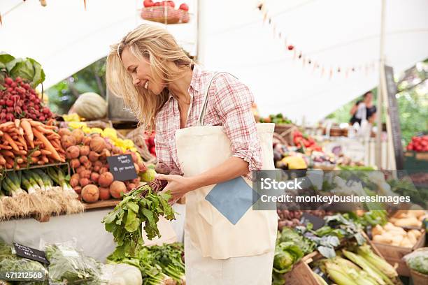 Female Customer Shopping At Farmers Market Stall Stock Photo - Download Image Now - Market - Retail Space, Vegetable, Buying