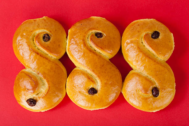 three s shaped loaves of swedish lucia bread - lussebulle bildbanksfoton och bilder