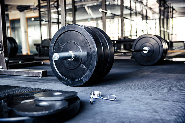 Closeup image of a fitness equipment Closeup image of a fitness equipment in gym barbell stock pictures, royalty-free photos & images