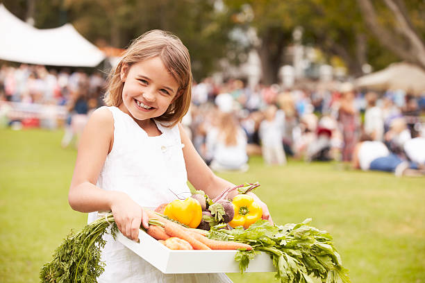 Girl With Fresh Produce Bought At Outdoor Farmers Market Girl With Fresh Produce Bought At Outdoor Farmers Markett, Smiling To Camera agricultural fair stock pictures, royalty-free photos & images