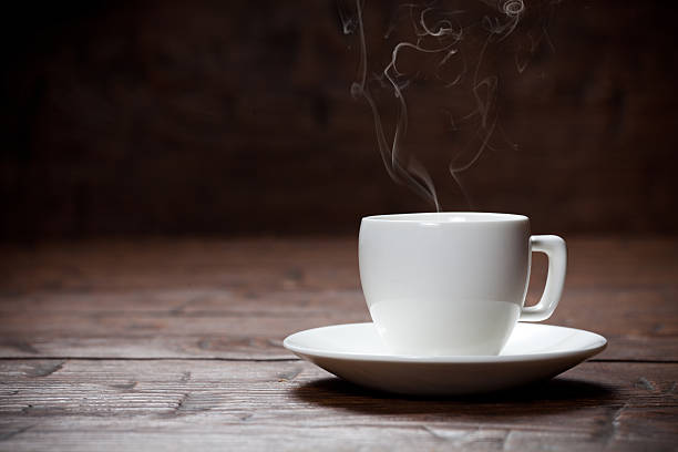 istock Coffee cup and saucer on old wooden table. 471217904