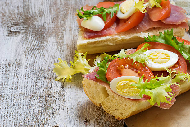 istock Sandwich with ham, salad, eggs and tomato 471218098
